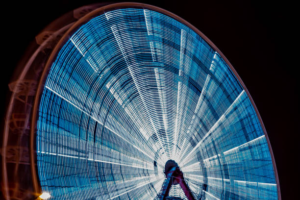 Germany, Berlin, December 15, 2023 - Blurred motion of ferris wheel at night, Berlin central