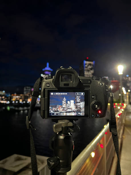 istock A camera on a tripod captures a night view of Vancouvers skyline, with the iconic Harbour Centre Tower illuminated in the background 2167702680