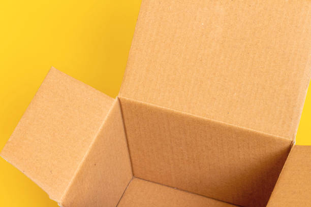 istock open cardboard box on yellow background 2167703007