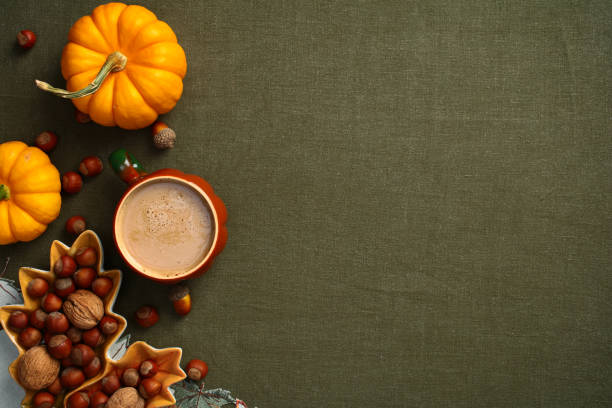 istock Flat lay composition with pumpkins, maple leaf shaped plate with nuts, acorns on green table cloth. Autumn, Fall, Thanksgiving concept. 2167703928