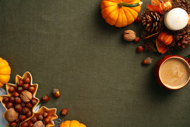 istock Vintage autumn flat lay composition. Pumpkins, acorns, nuts, coffee cup on green table cloth. Top view with copy space. Autumn, Fall, Thanksgiving concept. 2167704105