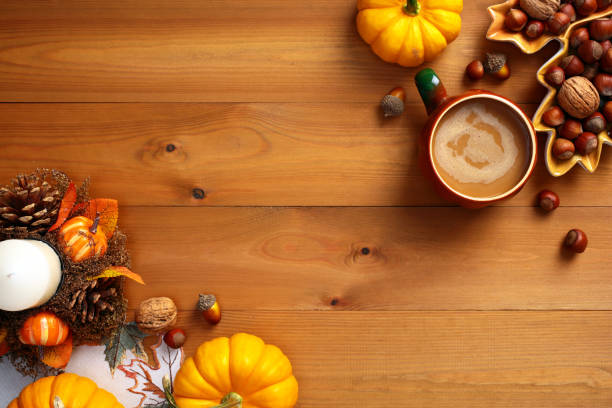 istock Thanksgiving or fall concept. Autumn background with pumpkins, fall decor, nuts, coffee cup on wooden desk table. Top view. 2167704758