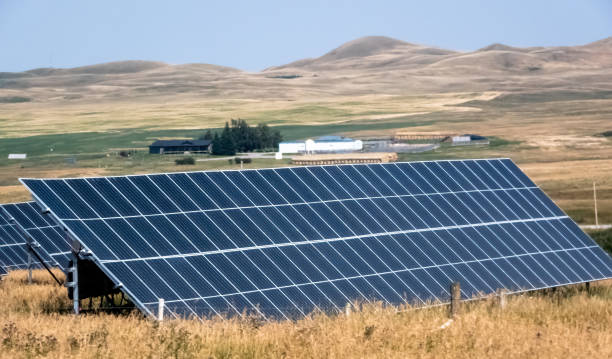 istock A vast solar array stretches across a sun-drenched landscape, harnessing clean energy amidst rolling hills and a distant ranch. 2167705013