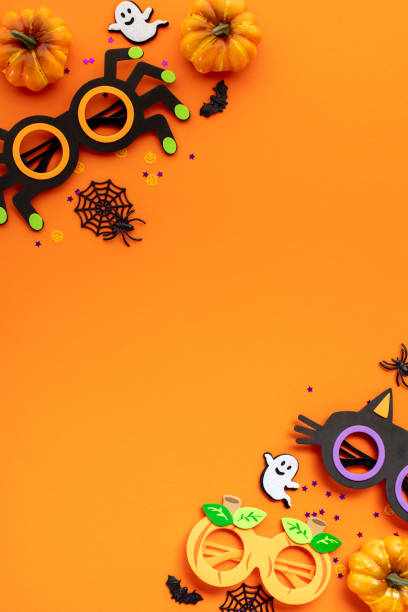 istock Happy Halloween concept. Flat lay composition with spooky party decorations, eyeglasses, ghosts, spiders on orange background. 2167705473