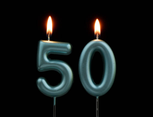 istock Blue birthday candles isolated on black background, number 50 2167707399