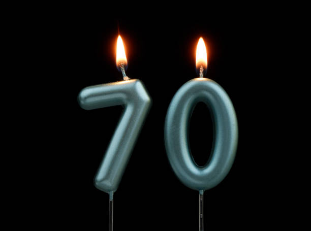 istock Blue birthday candles isolated on black background, number 70 2167707445
