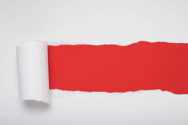 istock Torn white paper revealing a orange background. Space for text. 2167708830