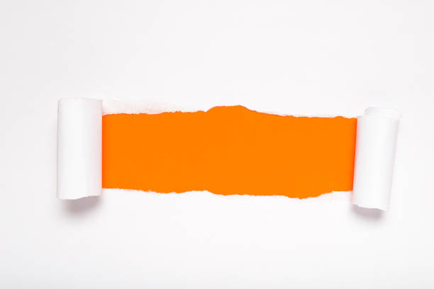 istock Torn white paper revealing a orange background. Space for text. 2167708862