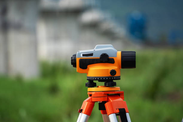 istock A surveying instrument is on a tripod in a grassy field 2167709624