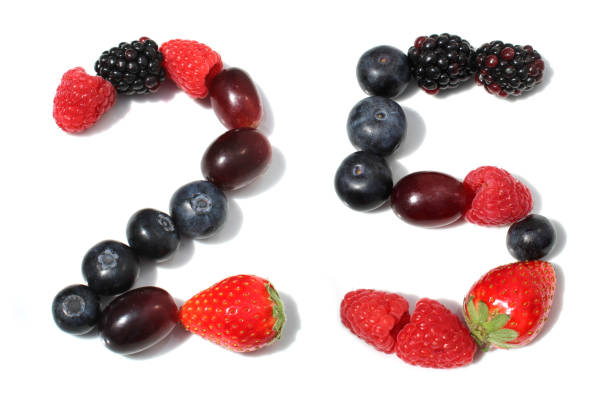istock berry anniversary number 25, twenty five, from berries: raspberry, blackberry, strawberry with green leaf, blueberries, grape 2167709654