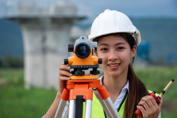 istock Construction workers wearing a white helmet and a yellow vest is holding a measuring device 2167710020