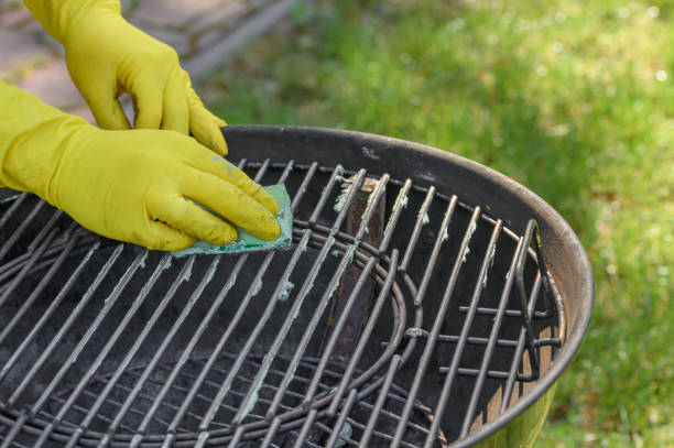 istock Wash and scrub the dirty grill grate with a kitchen sponge 2167712082