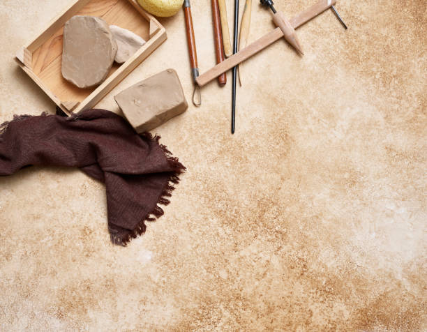 istock Making ceramic, women's hands and tools on the decorative table style background, up view. 2167717473