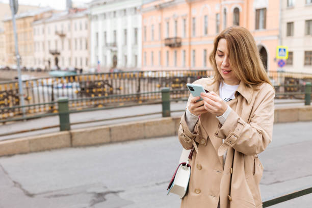istock Female tourist talking on smartphone while walking in old town, copy space. 2167718023