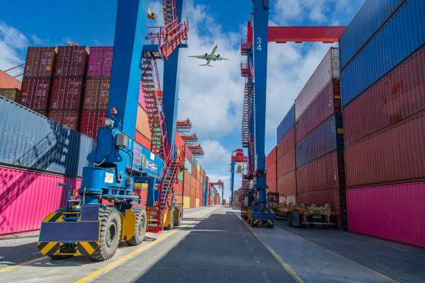 Airplane flying above container port. Transportation concept.