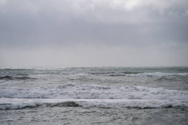 Rough ocean waves on a cloudy afternoon on the West Coast of New Zealand.