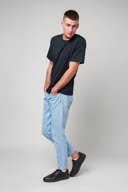 istock Young Man Wearing Black T-Shirt Against White Background 2167722895
