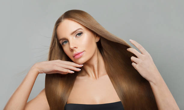 istock Charming female model brunette with long hair and natural make-up posing isolated on white background 2167725838