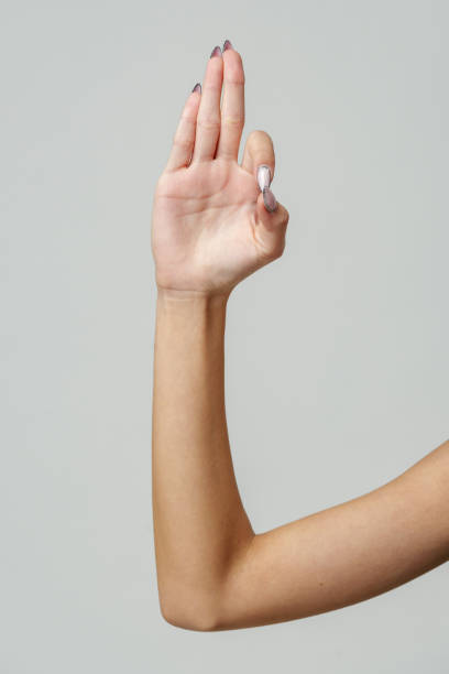 istock Woman's Hand Showing Three Fingers Against a Light Grey Background 2167727211