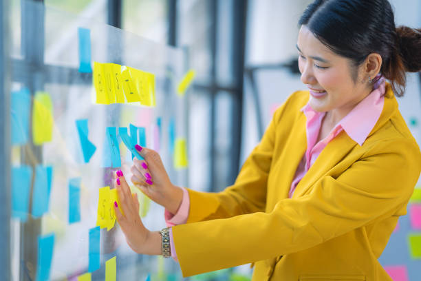 istock Asian accountant doing accounting, payables, assets, book value, expenses, gross profit, diversification, liquidity with financial graph documents and laptop. 2167728311