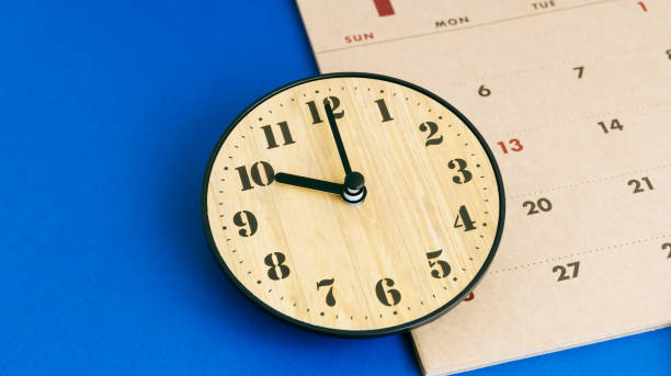 istock Clock and calendar on a blue background. Business time management and schedule adjustment. 2167729795