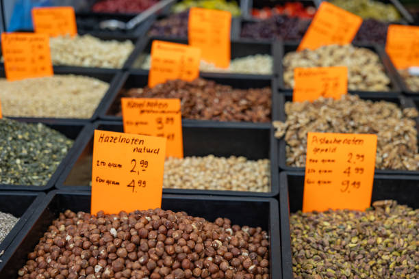 Different type of seed and nuts, market stall in Rotterdam. Raw, food, ingredient, almonds, sunflower seeds, market trader, price tags.