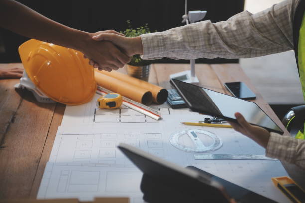 istock Architect men making handshake in construction site. Employee or worker shake hands to employer man for greeting, dealing, teamwork, collaboration some project or business. They are good team 2167732842