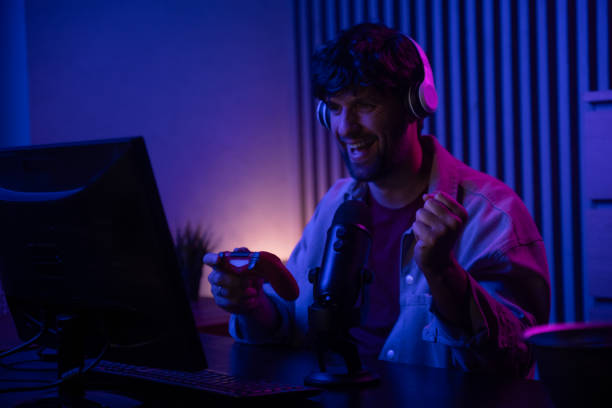 istock Gamer Achieves Victory While Commentating In Stylish Purple-Illuminated Room 2167735563
