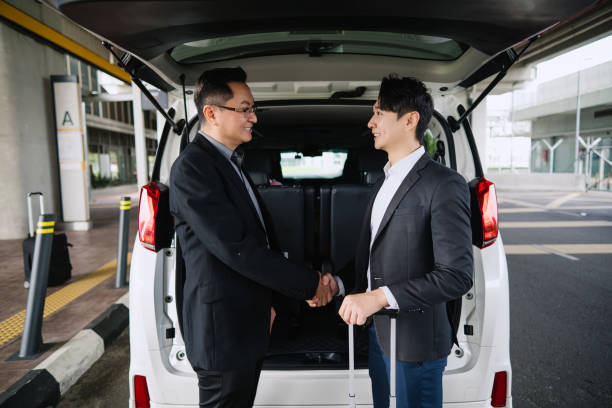 istock Two Asian businessmen shaking hands before leaving. 2167740753
