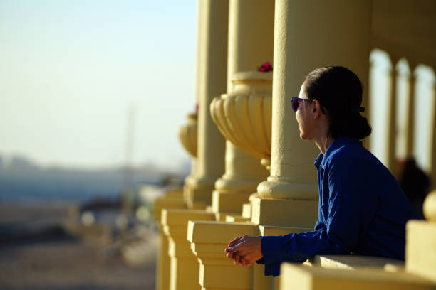 Woman on promenade at sunset, Pergola next to the sea in Foz, Portugal stock photo