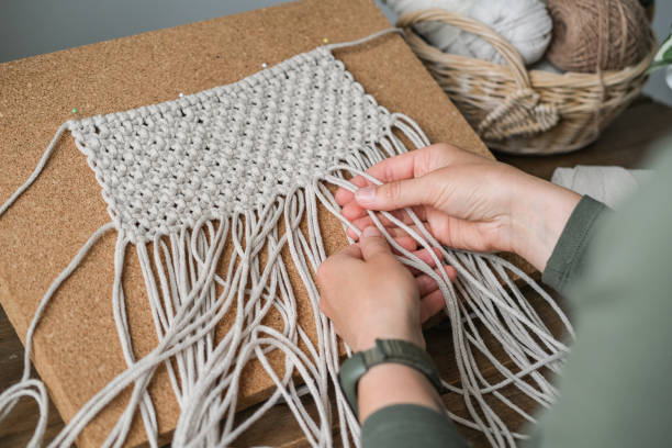 istock Close up of female hands weaving macrame 2167748653