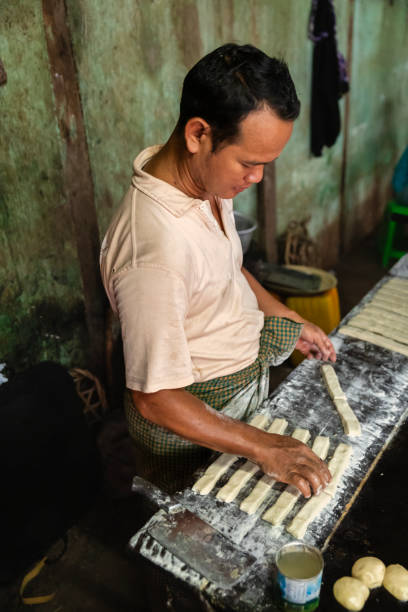 istock Burmese man preparing and selling fresh Chinese doughnuts, Myanmar 2167748990