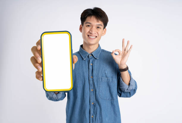 istock portrait of young Asian man using phone on white background 2167757481
