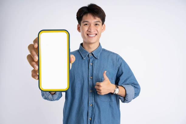 istock portrait of young Asian man using phone on white background 2167757483