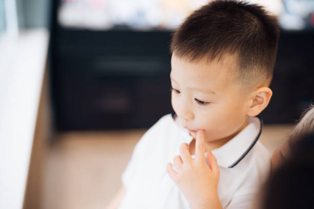 Asian boy looking at the cake