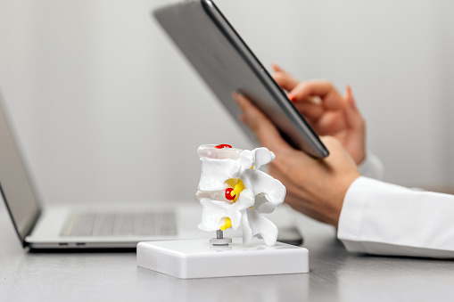 A Doctor Uses A Laptop And Tablet At Their Workstation With A Detailed A Doctor Uses A Laptop And Tablet At Their Workstation With A Detailed