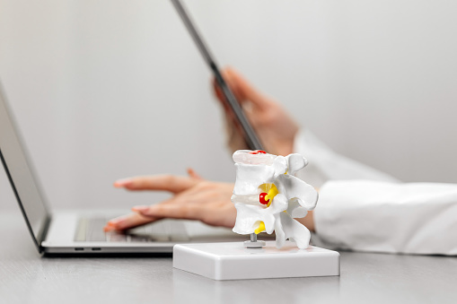 A Doctor Uses A Laptop And Tablet At Their Workstation With A Detailed A Doctor Uses A Laptop And Tablet At Their Workstation With A Detailed