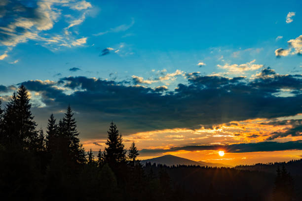The most beautiful landscape with peaks in the background, sky with clouds at sunset.