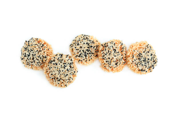 istock Rice cracker with sugar cream and white sesame and black sesame toppings isolated on white background, Homemade biscuits, Thai name is Khao Tan 2167771021