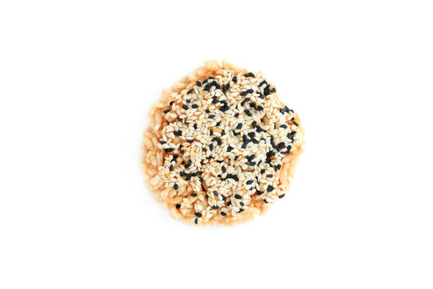 Rice cracker with sugar cream and white sesame and black sesame toppings isolated on white background, Homemade biscuits, Thai name is Khao Tan
