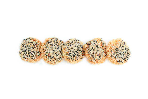 istock Rice cracker with sugar cream and white sesame and black sesame toppings isolated on white background, Homemade biscuits, Thai name is Khao Tan 2167771023