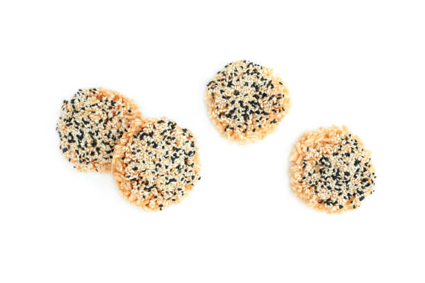 istock Rice cracker with sugar cream and white sesame and black sesame toppings isolated on white background, Homemade biscuits, Thai name is Khao Tan 2167771025