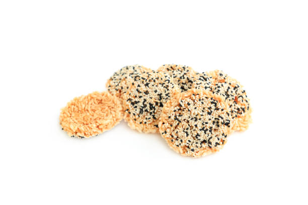 Rice cracker with sugar cream and white sesame and black sesame toppings isolated on white background, Homemade biscuits, Thai name is Khao Tan