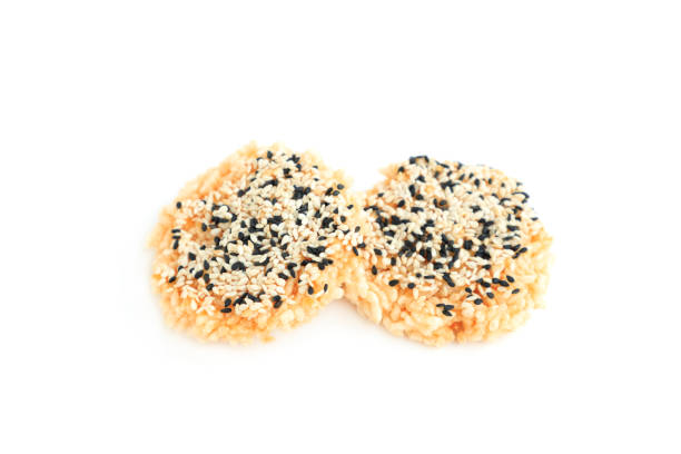 istock Rice cracker with sugar cream and white sesame and black sesame toppings isolated on white background, Homemade biscuits, Thai name is Khao Tan 2167771035