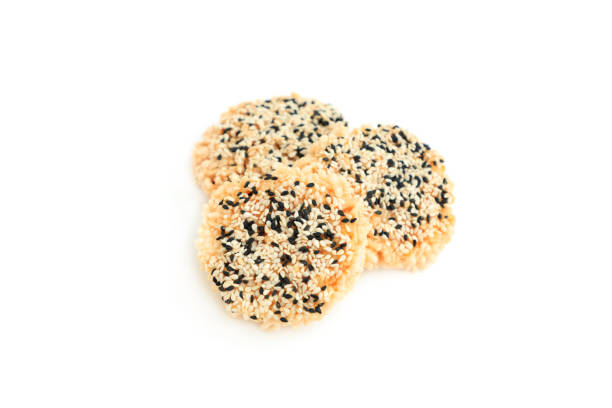 istock Rice cracker with sugar cream and white sesame and black sesame toppings isolated on white background, Homemade biscuits, Thai name is Khao Tan 2167771055