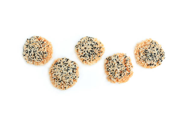 istock Rice cracker with sugar cream and white sesame and black sesame toppings isolated on white background, Homemade biscuits, Thai name is Khao Tan 2167771200