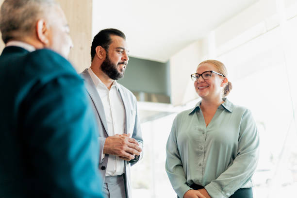 istock Coworkers talking in lobby at hotel 2167772052