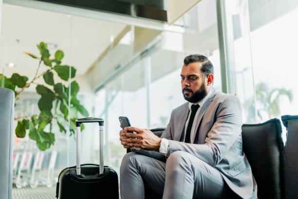 istock Bussinesman using mobile phone in lobby at hotel 2167772194