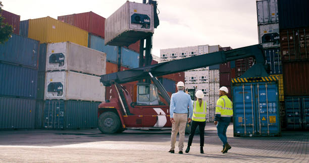 istock Container, inspection and supervisor talking to staff at commercial dock for supply chain logistics. Conversation, crane and shipping with team of people at harbor for export or import from back 2167775953