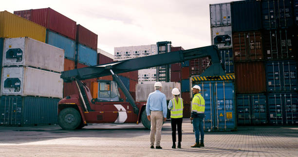 istock Container, staff and supervisor at commercial dock for stock or supply chain logistics from back. Conversation, inspection and shipping with team of people at harbor together for export or import 2167775959